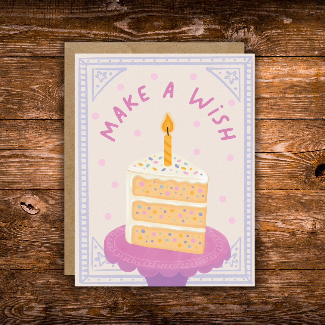 Pastel birthday greeting card featuring a slice of sprinkle cake with a lit candle and the words "Make a Wish."