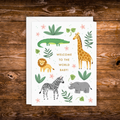 Gender-neutral baby greeting card featuring adorable safari animals including a giraffe, lion, zebra, crocodile, and rhino with greenery and the words "Welcome to the World Baby!"