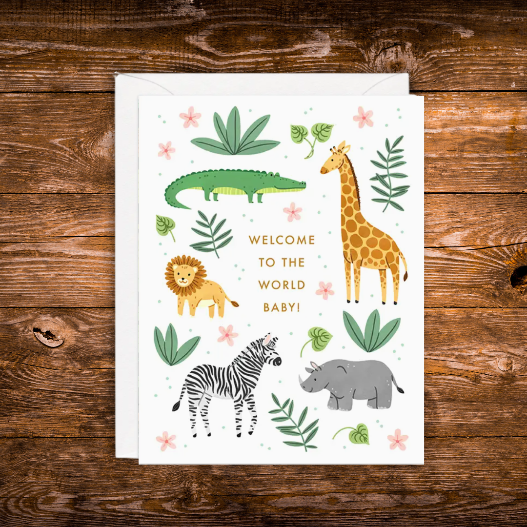 Gender-neutral baby greeting card featuring adorable safari animals including a giraffe, lion, zebra, crocodile, and rhino with greenery and the words "Welcome to the World Baby!"