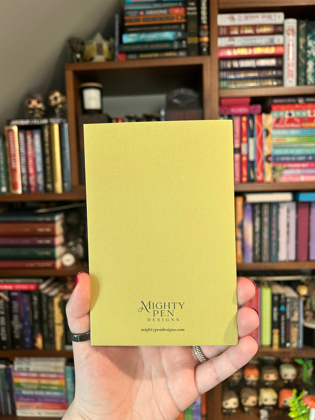Back of Green card with Mighty Pen Designs logo.