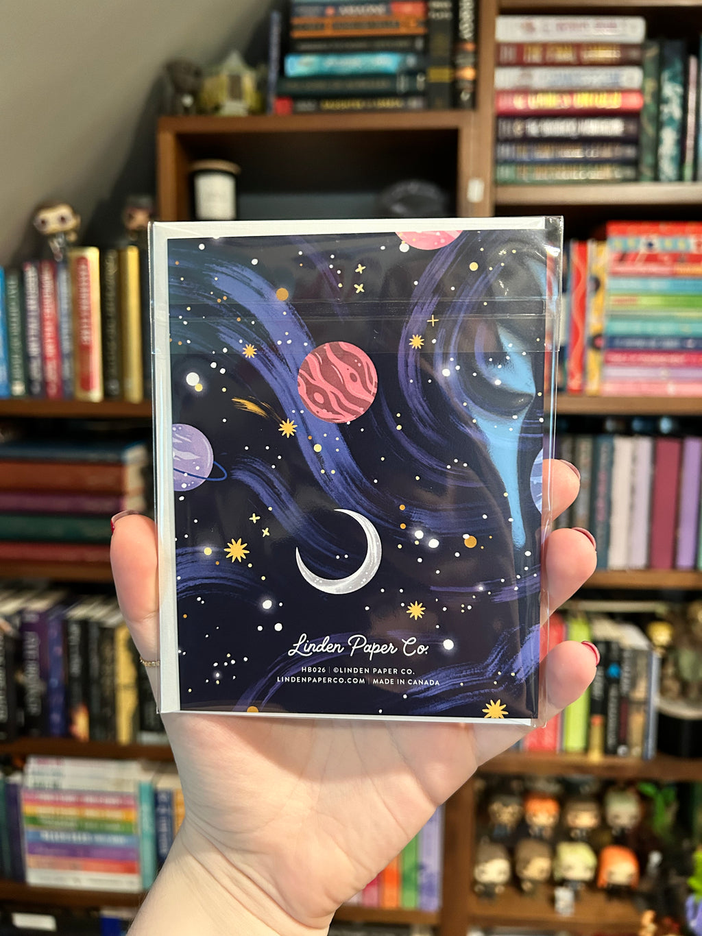 Back of space-themed birthday greeting card featuring printer information- Linden Paper Co. Printed in Canada- on a navy blue night sky background.