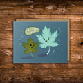 Landscape encouragement greeting card featuring two smiling illustrated leaves with the message "I Be-Leaf in You!" on a blue background.