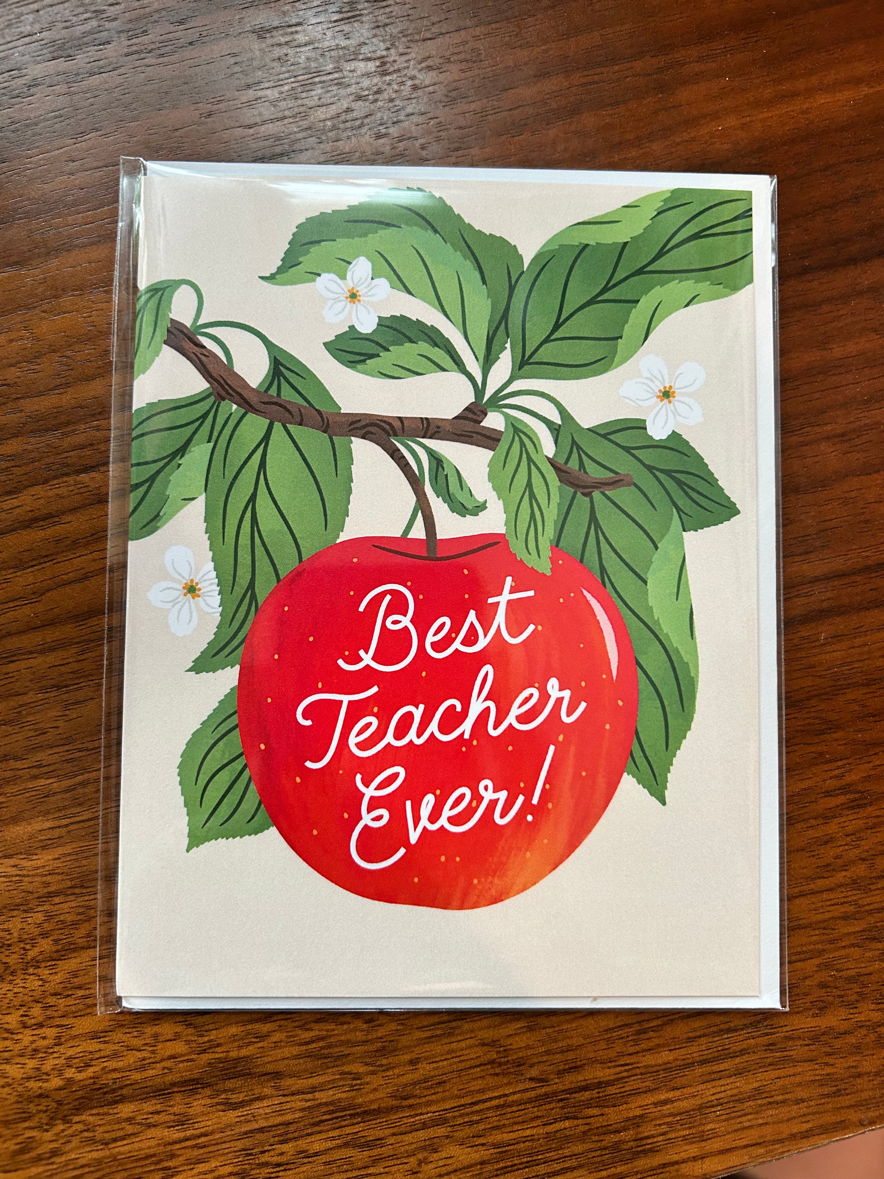 Teacher appreciation greeting card featuring a bright red apple hanging from a leafy branch with white blossoms and the words "Best Teacher Ever!" in white script.