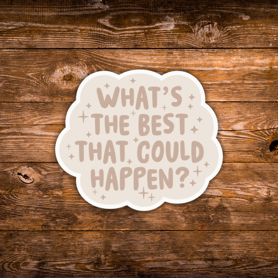 A die-cut sticker with the phrase 'WHAT'S THE BEST THAT COULD HAPPEN?' in a dusty cream font on a cream background, surrounded by small cream stars, shown on a rustic brown wooden plank surface.
