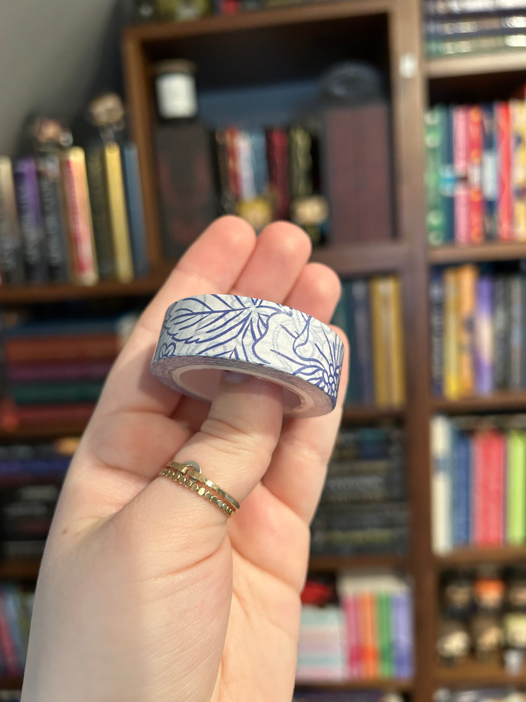 Decorative washi tape featuring blue botanical flowers, butterflies, berries, and leaves on a white background.