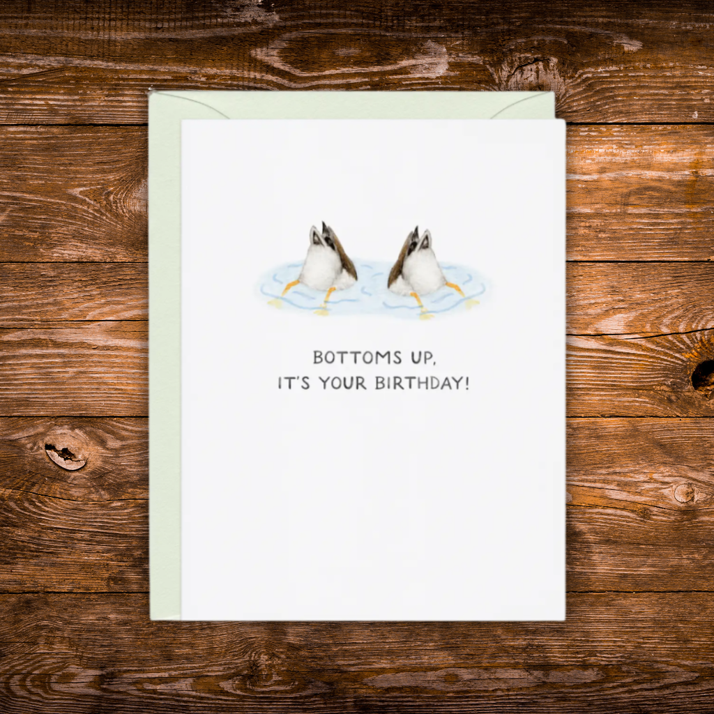 Birthday greeting card featuring two ducks diving underwater with the phrase "Bottoms Up, It's Your Birthday!"
