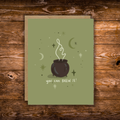 Encouragement greeting card featuring a bubbling cauldron surrounded by stars and crescent moons with the message "You Can Brew It!" on a sage green background.
