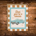 Father's Day greeting card featuring a vintage blue classic car with the message "Dad, You're a Classic" on a retro striped background.