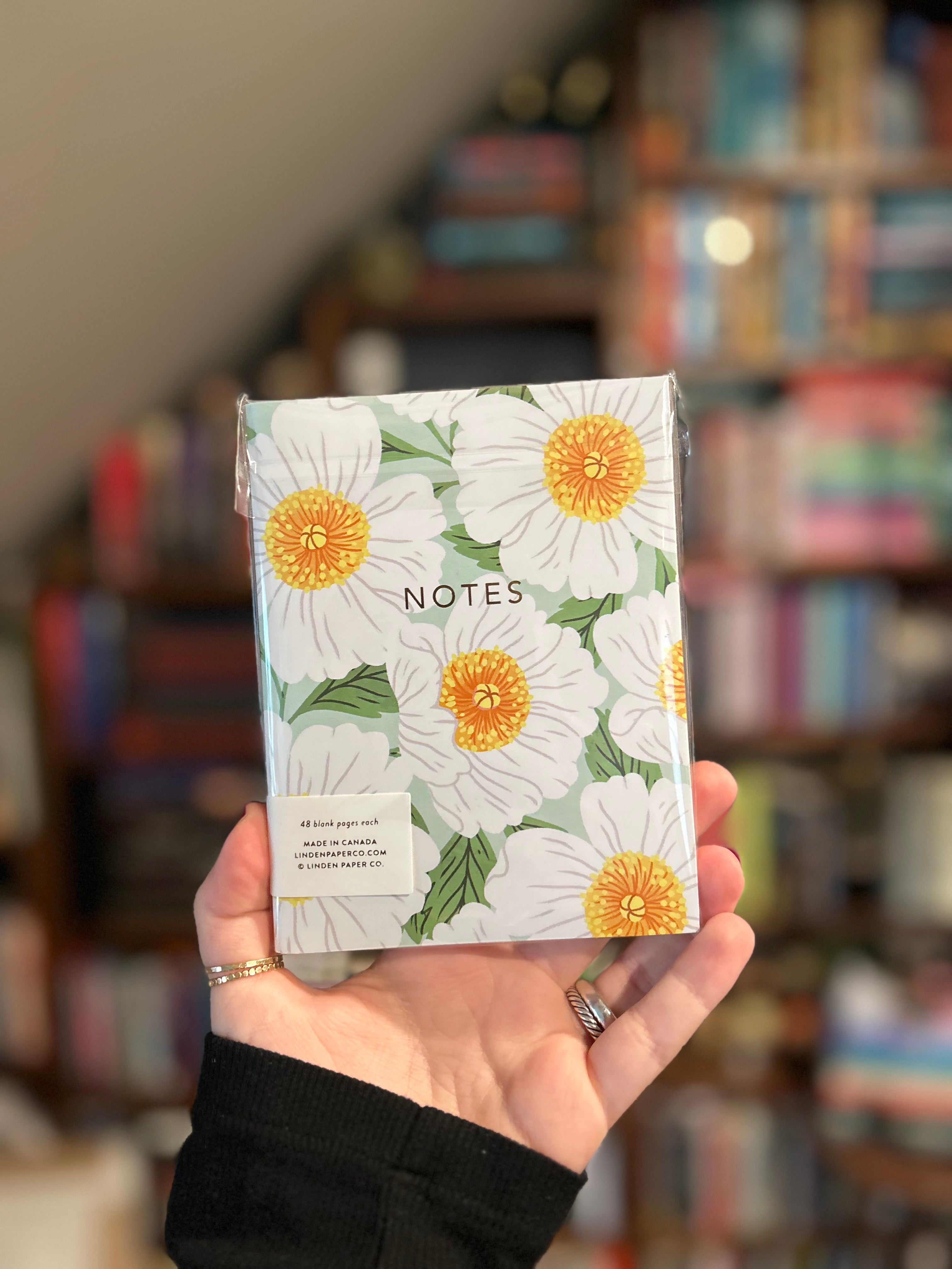 Floral notebook featuring daisy botanical cover designs with gold foil details, 44 blank pages, and saddle stitched binding.