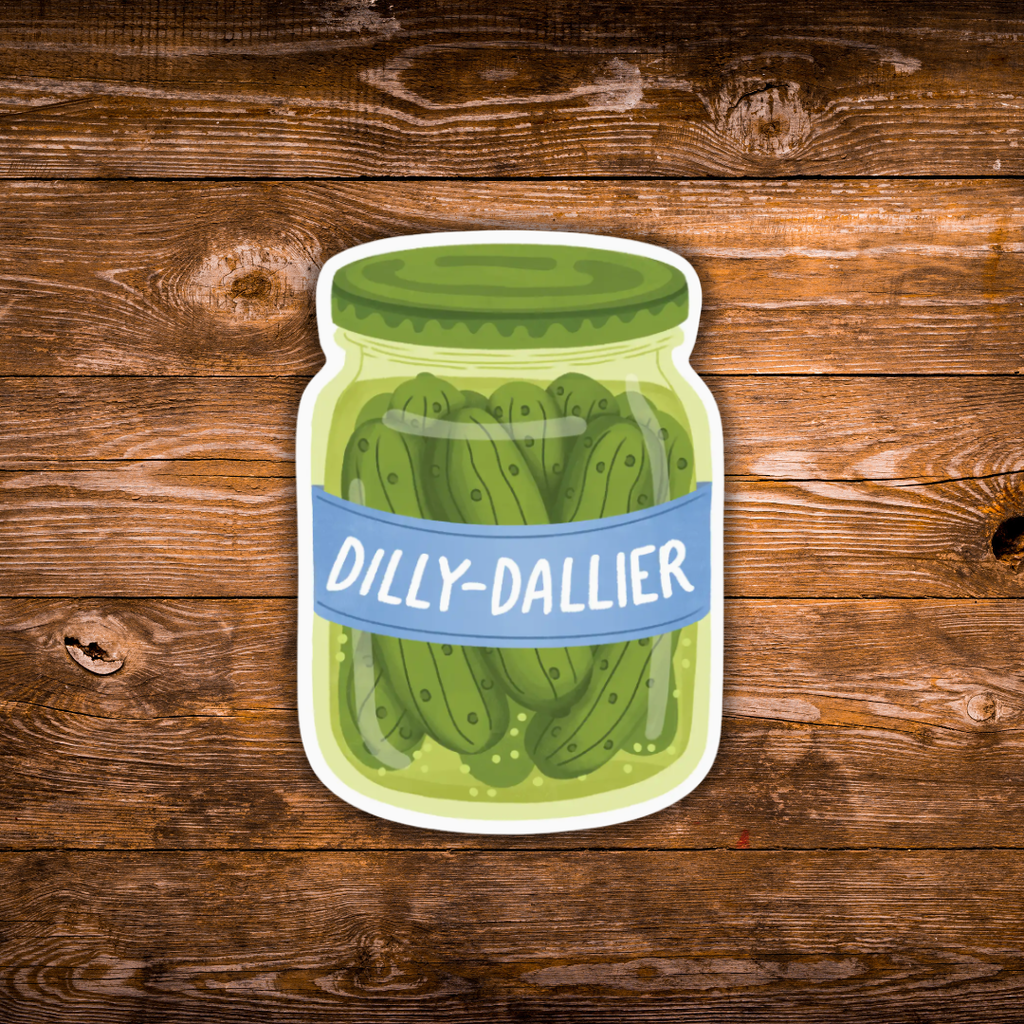 A die-cut sticker of a cartoon pickle jar with the text 'DILLY-DALLIER' on a blue label, shown against a rustic brown wooden plank background.