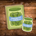 A greeting card and matching die-cut sticker featuring an illustrated jar of pickles with a blue banner reading 'ALWAYS DILL-ITED to celebrate you' and 'DILLY-DALLIER', displayed on a rustic wooden surface.