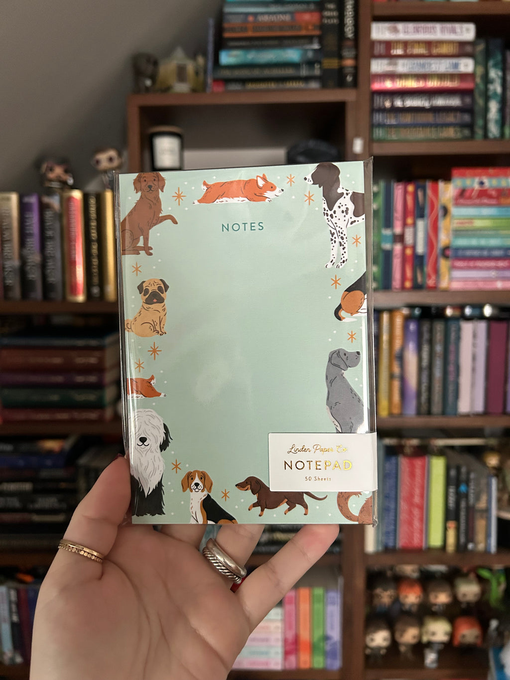Tear-away notepad featuring illustrated dogs of various breeds around the border with an open center for writing notes.