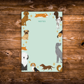 Tear-away notepad featuring illustrated dogs of various breeds around the border with an open center for writing notes.