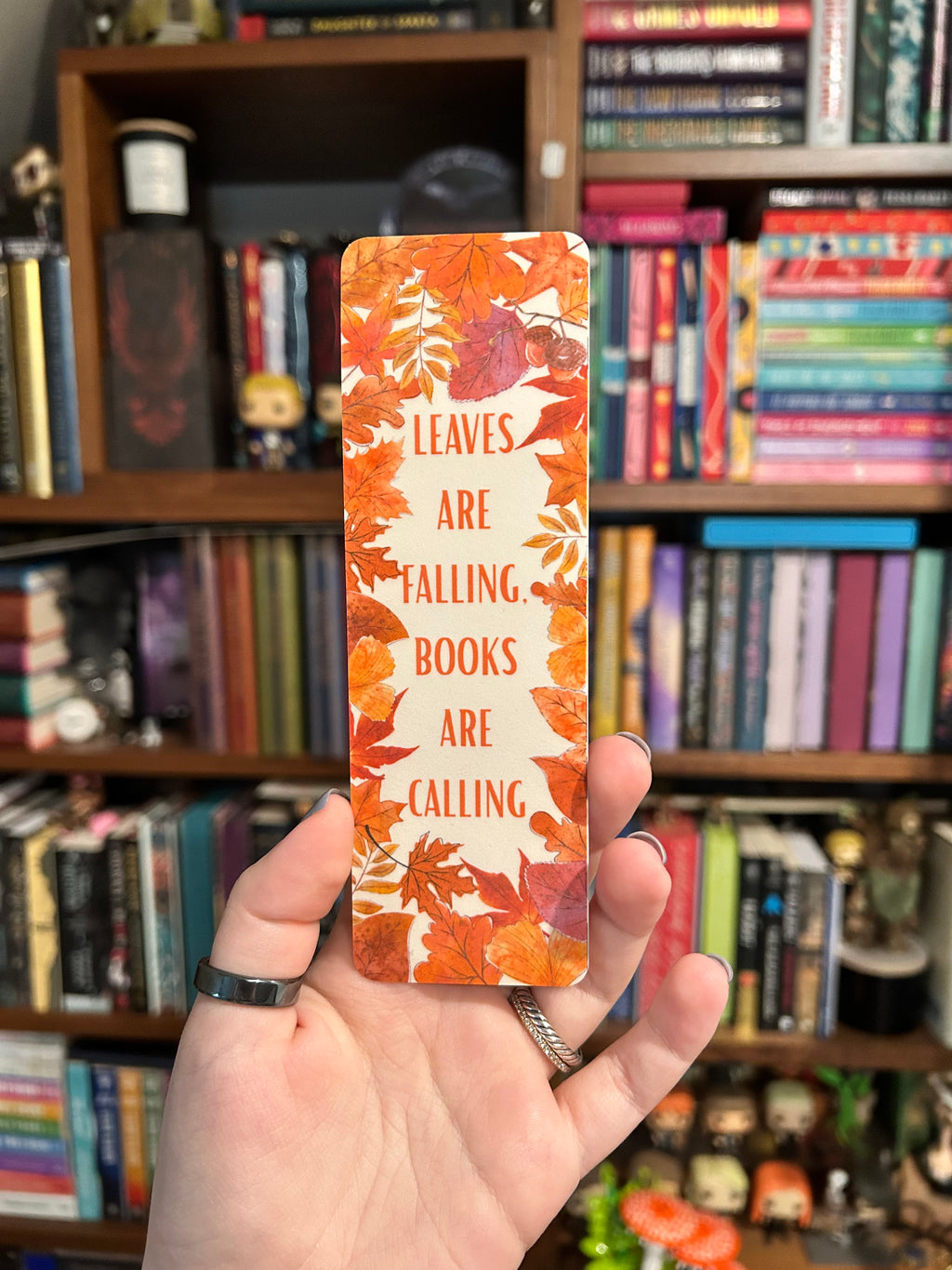 Autumn bookmark with colorful fall leaves and the phrase “Leaves Are Falling, Books Are Calling” 