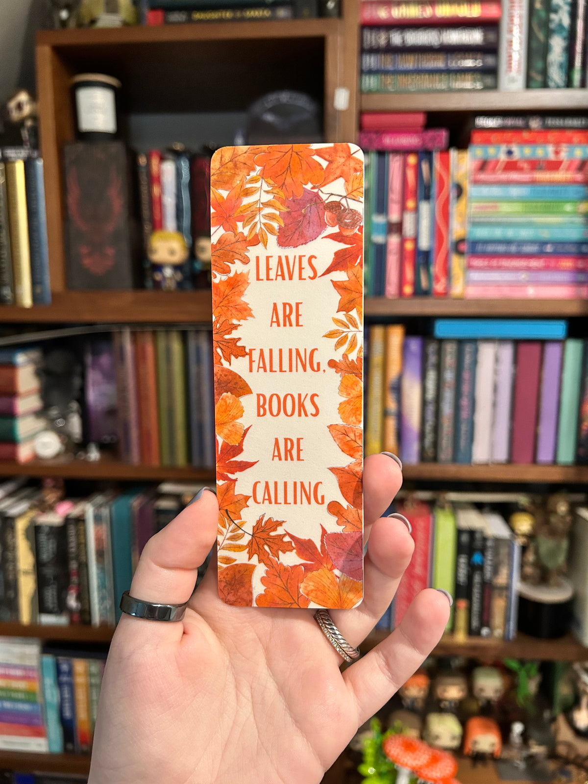 Autumn bookmark with colorful fall leaves and the phrase “Leaves Are Falling, Books Are Calling” 