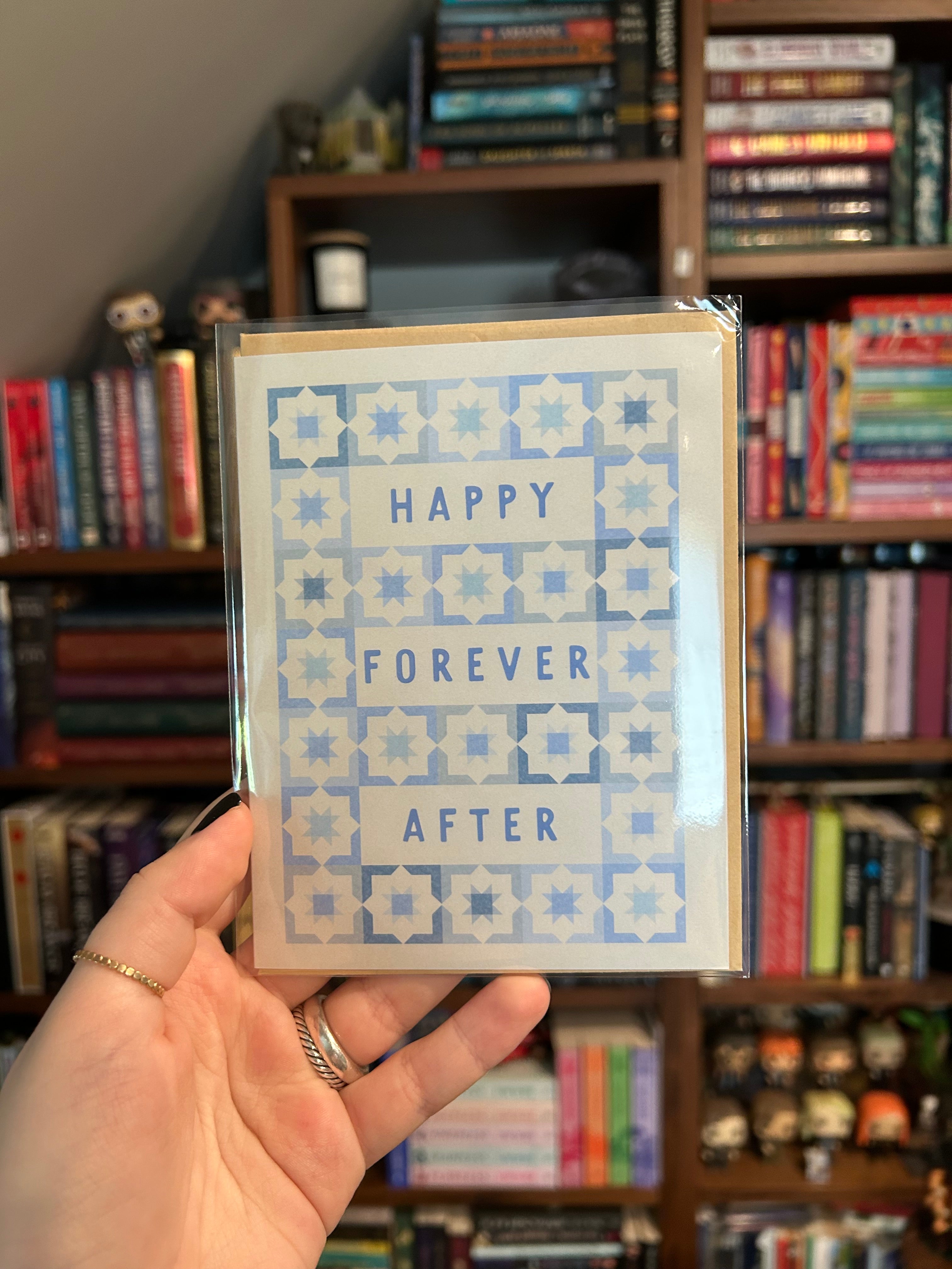 Modern wedding greeting card featuring the words "Happy Forever After" surrounded by a blue geometric tile pattern on a white background.
