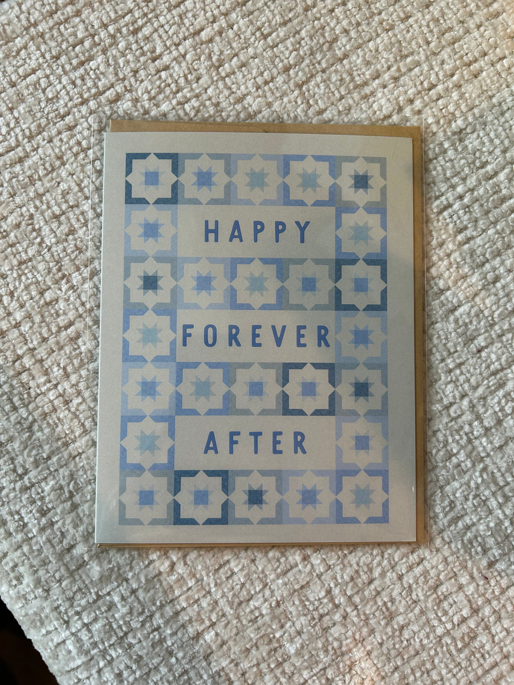 Modern wedding greeting card featuring the words "Happy Forever After" surrounded by a blue geometric tile pattern on a white background.