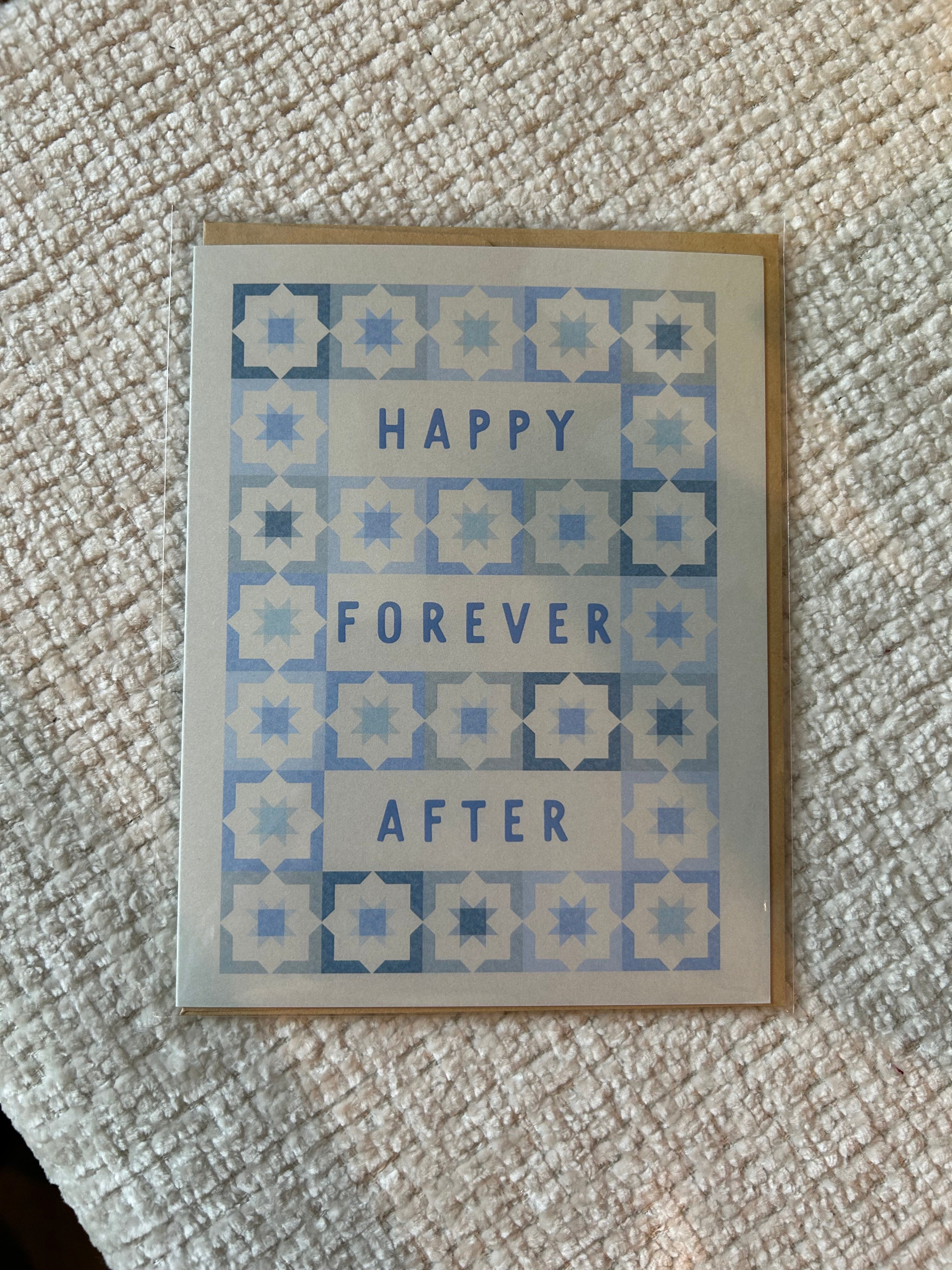 Modern wedding greeting card featuring the words "Happy Forever After" surrounded by a blue geometric tile pattern on a white background.