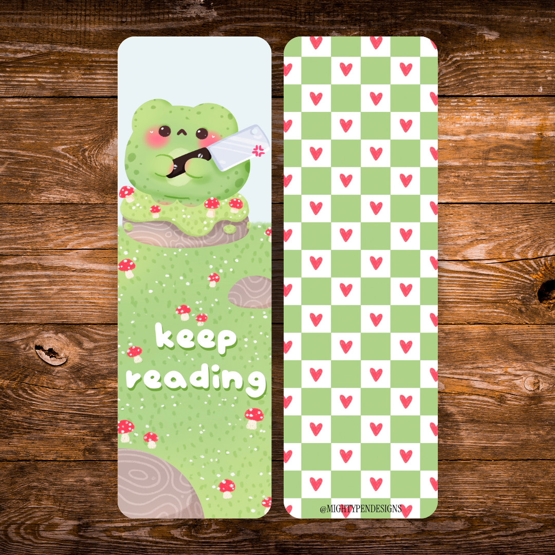 Double-sided frog bookmark featuring a cute green frog holding a cleaver in a mushroom-covered woodland scene with “Keep Reading” lettering, paired with a green checkerboard pattern and pink hearts.