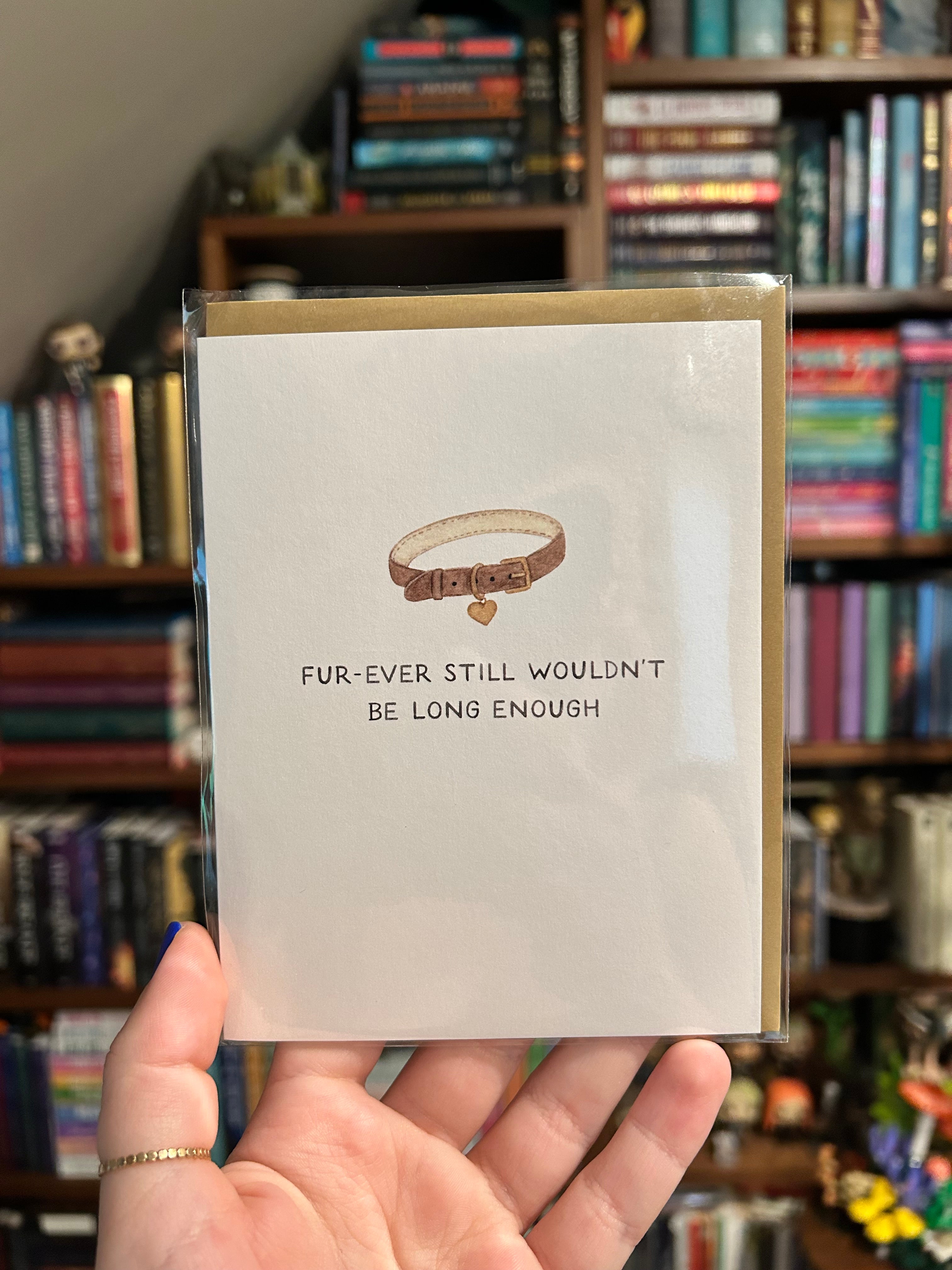 Minimalist pet sympathy greeting card featuring a brown pet collar with a heart-shaped tag and the message "Fur-Ever Still Wouldn't Be Long Enough" on a white background.