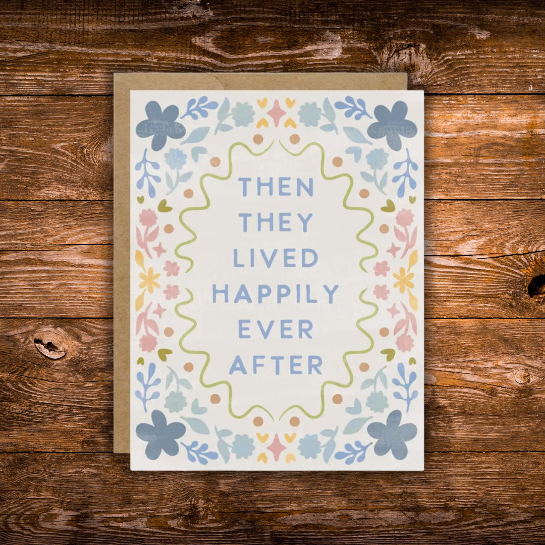 Pastel floral wedding greeting card featuring the phrase "Then They Lived Happily Ever After" surrounded by a colorful floral border.