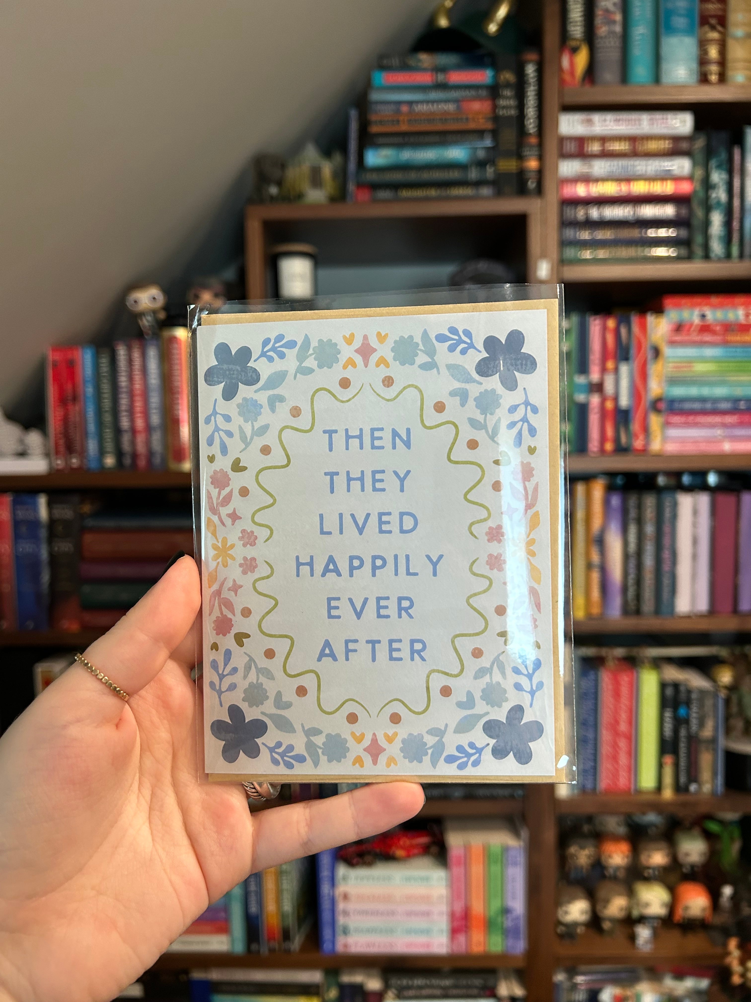 Pastel floral wedding greeting card featuring the phrase "Then They Lived Happily Ever After" surrounded by a colorful floral border.
