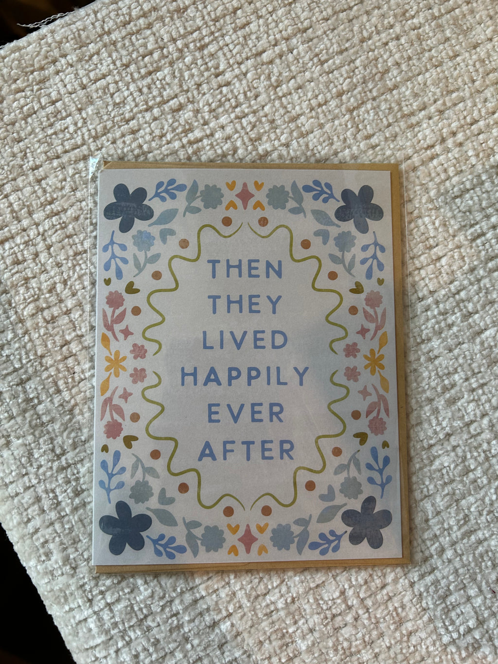 Pastel floral wedding greeting card featuring the phrase "Then They Lived Happily Ever After" surrounded by a colorful floral border.