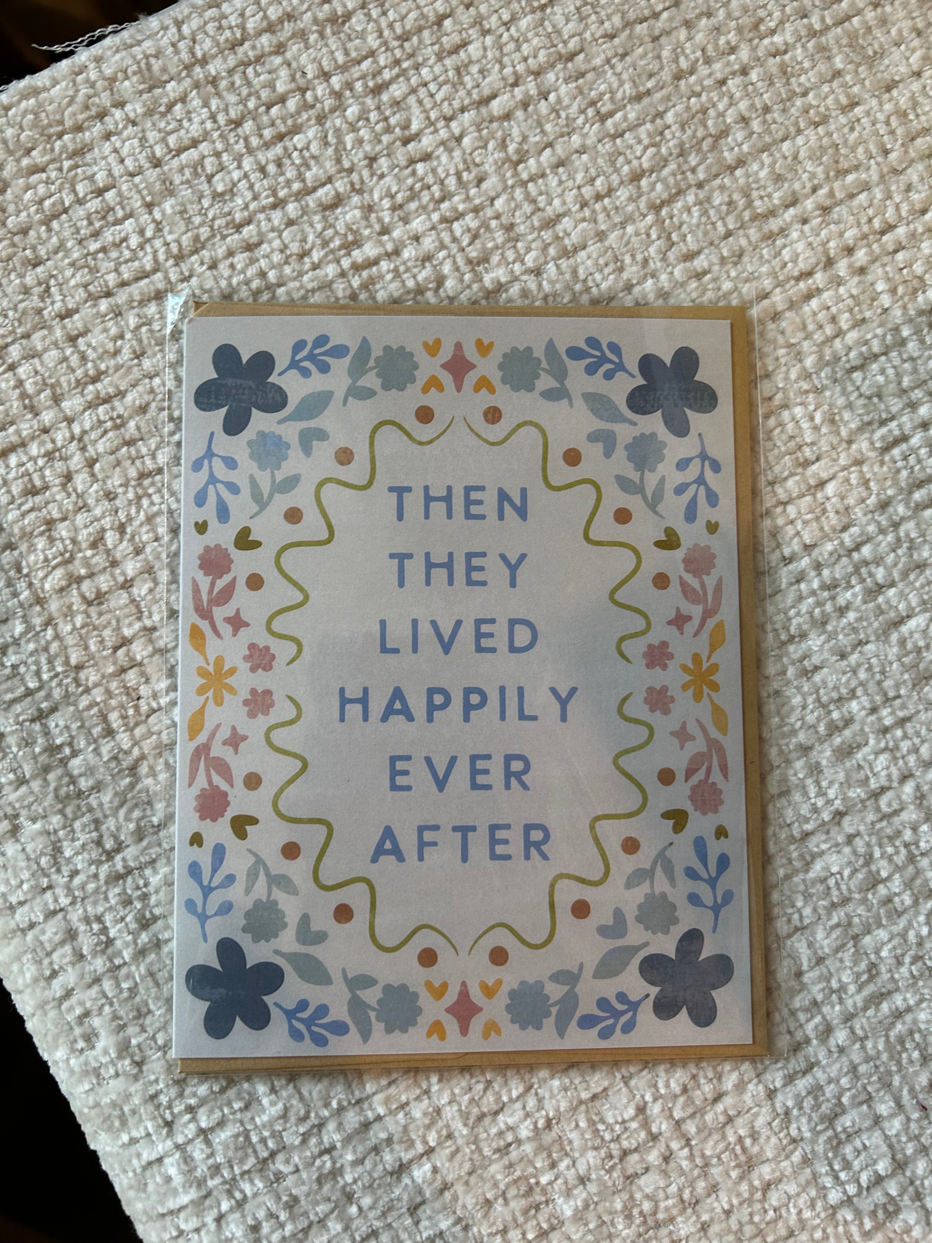 Pastel floral wedding greeting card featuring the phrase "Then They Lived Happily Ever After" surrounded by a colorful floral border.