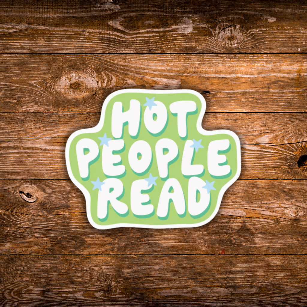 A die-cut sticker with the phrase 'HOT PEOPLE READ' in white bubble letters on a light green background with small blue star accents, shown on a rustic brown wooden surface.
