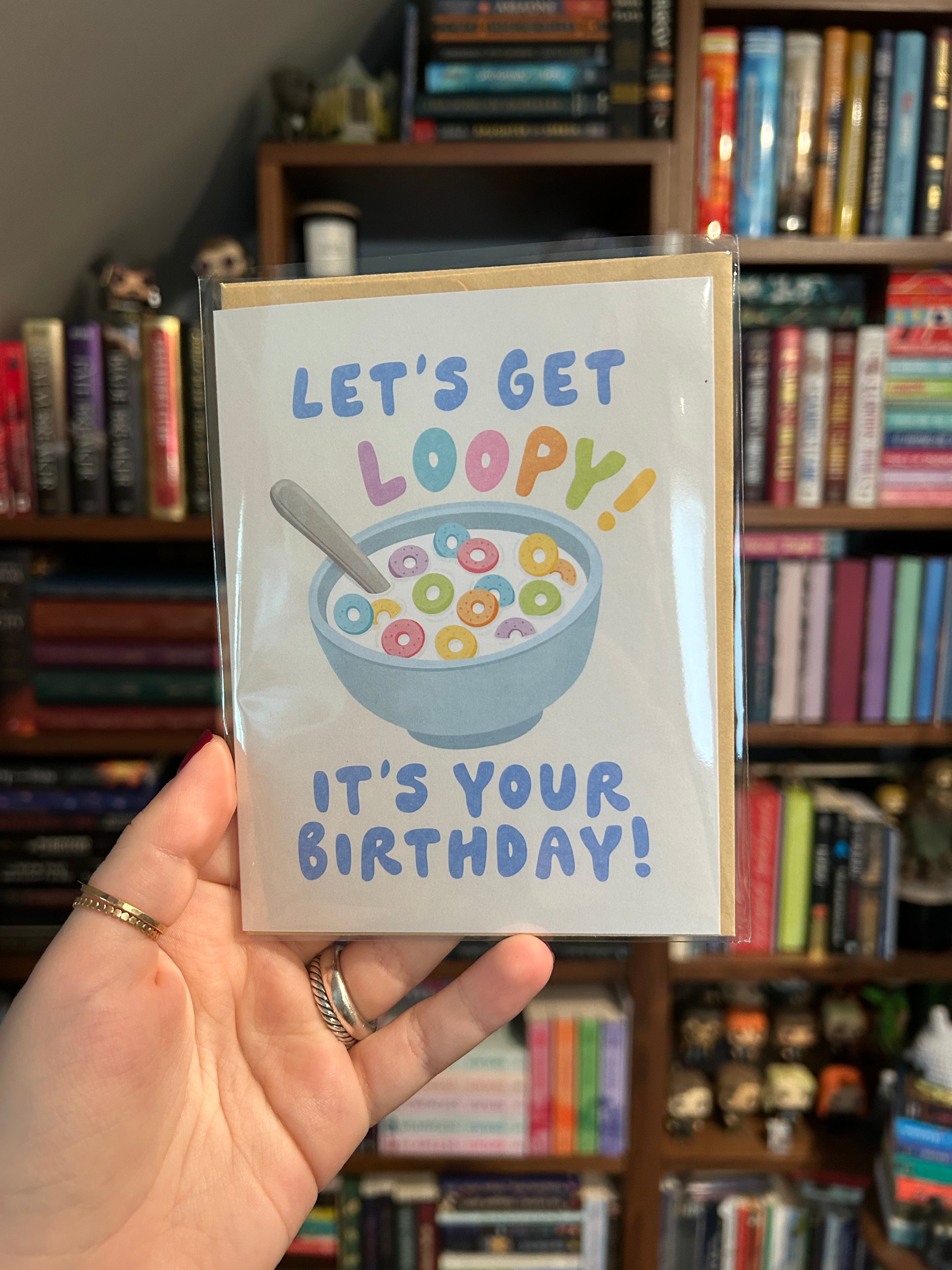 Funny cereal birthday card featuring a colorful bowl of cereal with the phrase "Let's Get Loopy! It's Your Birthday!"