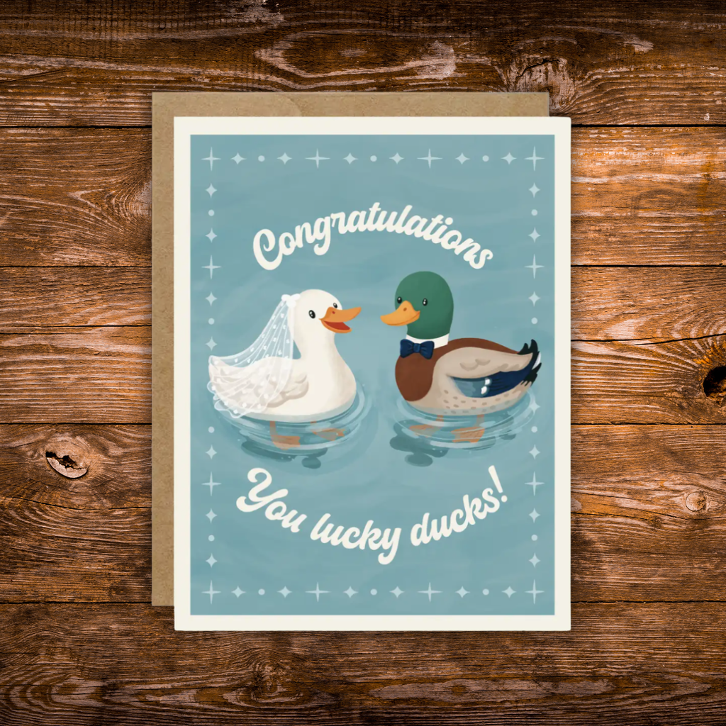 Wedding congratulations greeting card featuring a bride duck wearing a veil and a groom duck wearing a bow tie with the phrase "Congratulations You Lucky Ducks!"