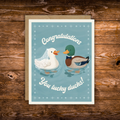 Wedding congratulations greeting card featuring a bride duck wearing a veil and a groom duck wearing a bow tie with the phrase "Congratulations You Lucky Ducks!"