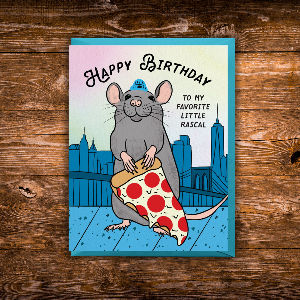 Funny birthday greeting card featuring a smiling New York City rat holding a giant slice of pepperoni pizza with the skyline in the background.