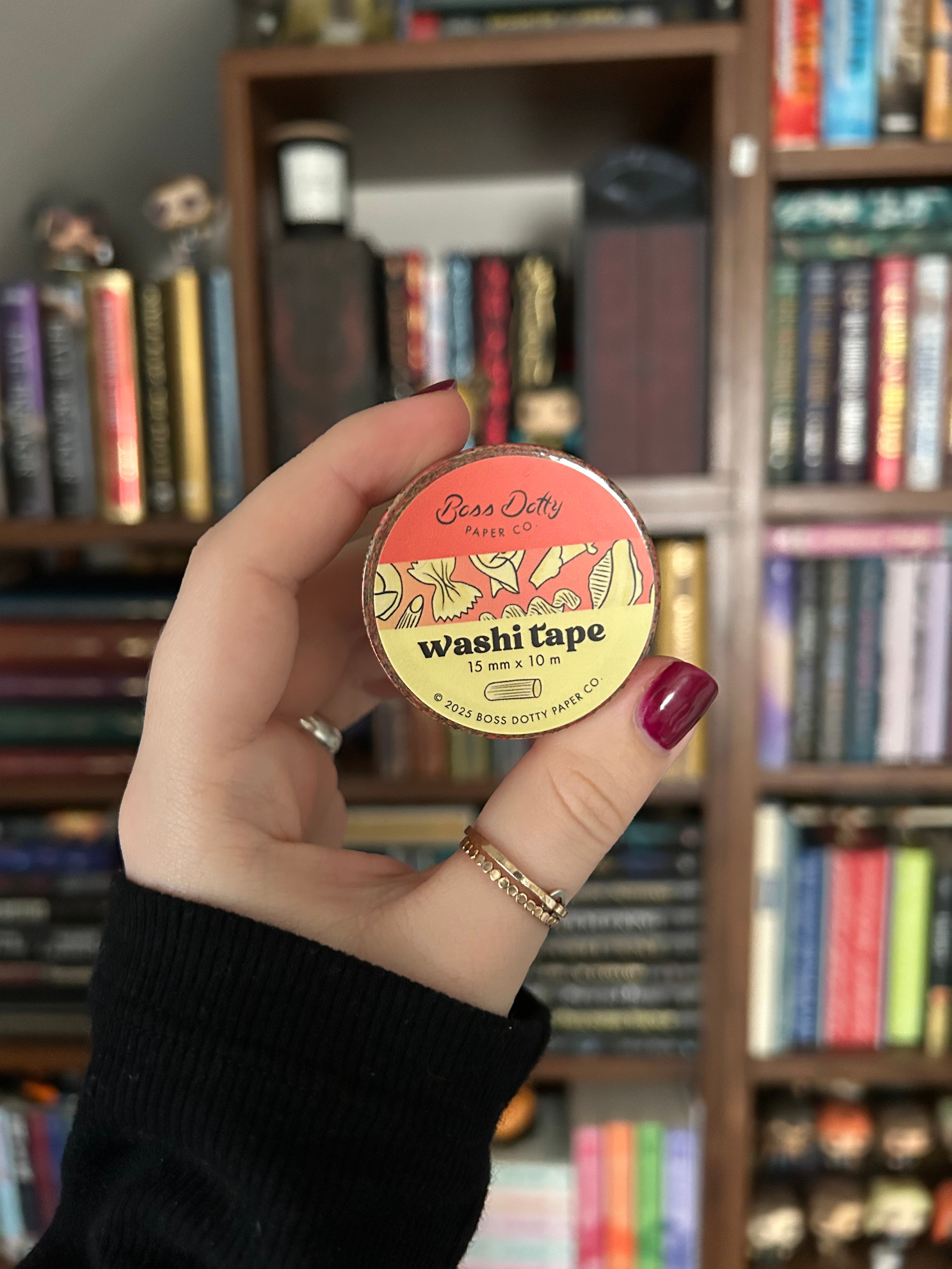Decorative washi tape featuring illustrated pasta shapes including ravioli, rigatoni, fusilli, shells, and farfalle on a red background.