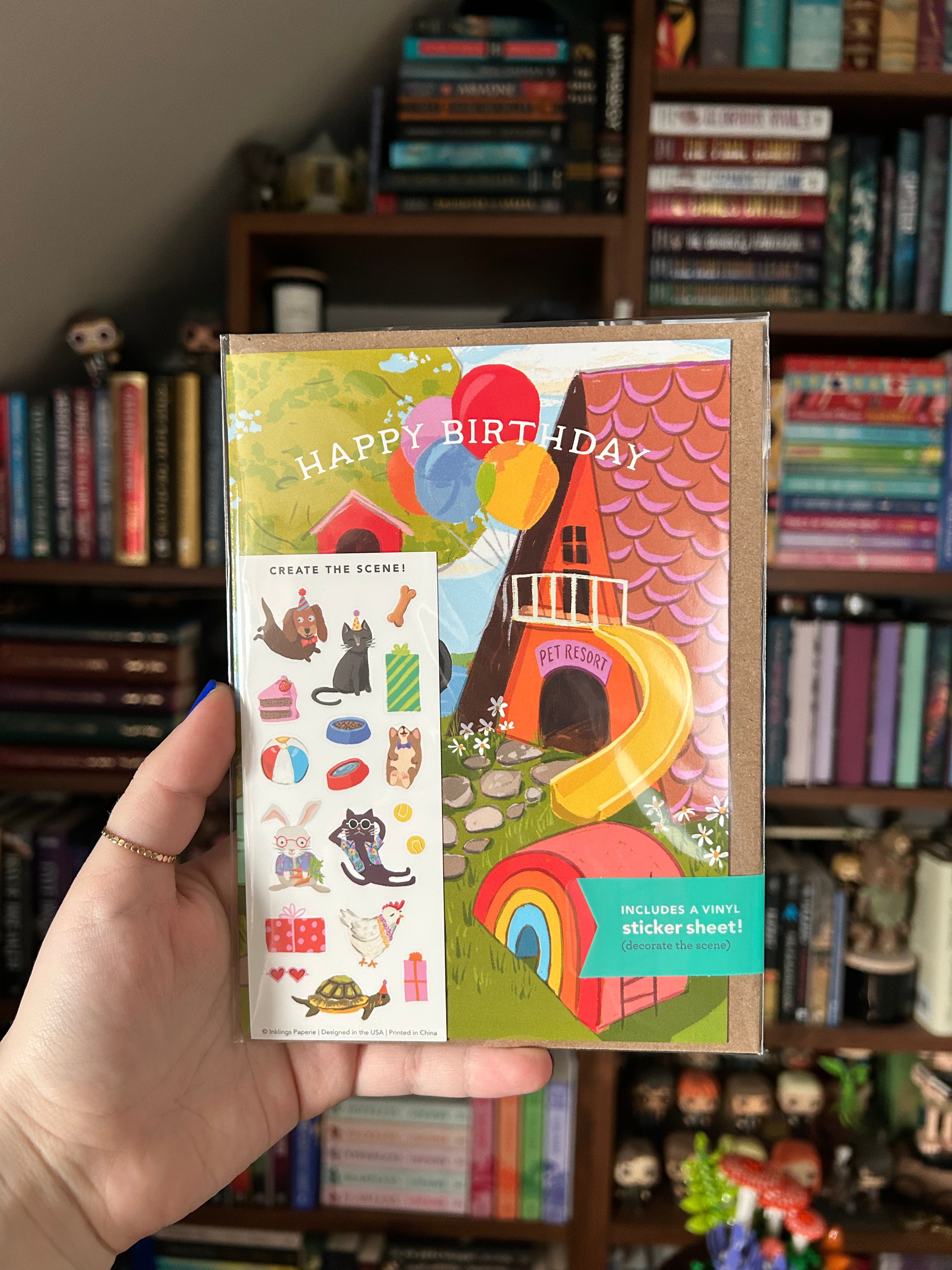 Interactive pet birthday greeting card featuring a whimsical pet resort with balloons, play areas, and a matching pet-themed sticker sheet with cats, dogs, rabbits, turtles, treats, and presents.