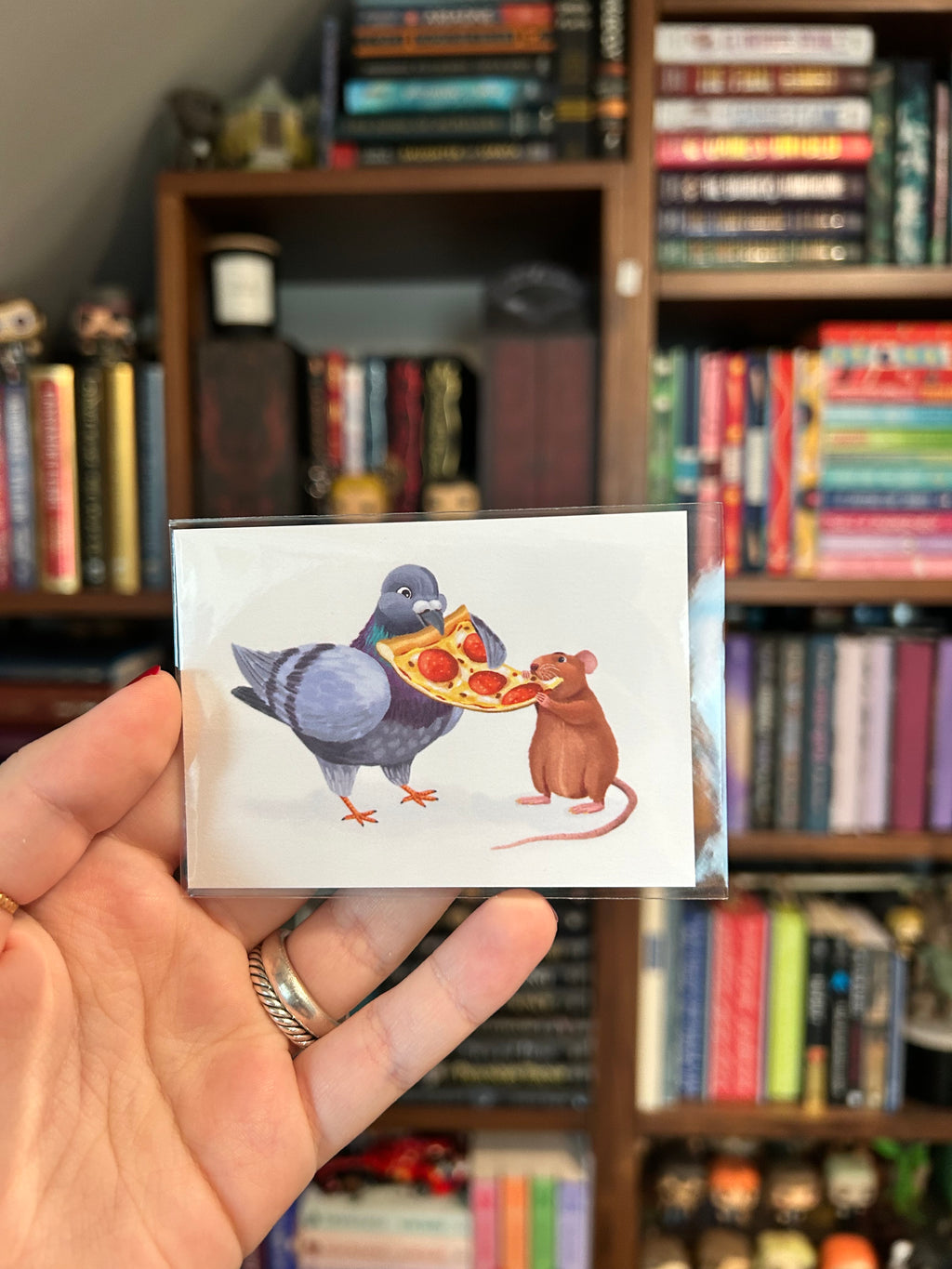 Mini art print featuring a pigeon and a rat sharing a slice of pepperoni pizza on a white background.