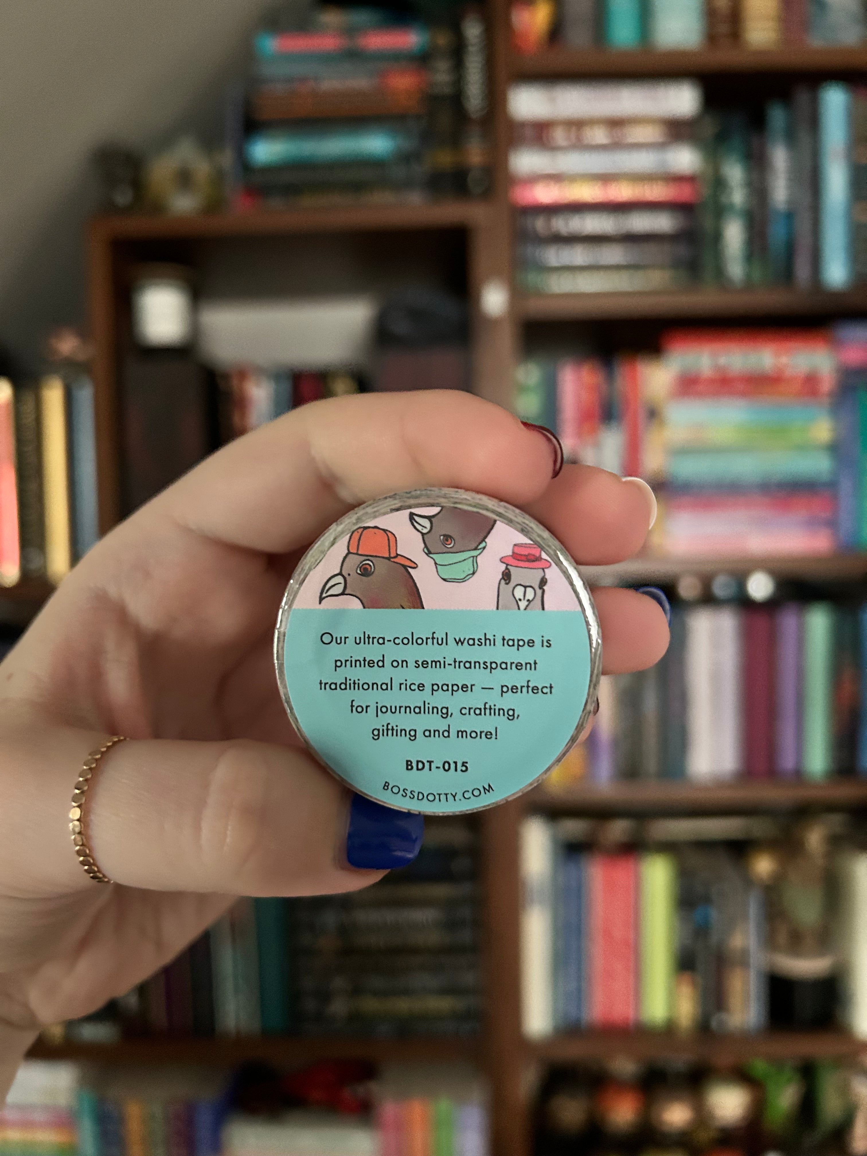 Decorative washi tape featuring whimsical New York City pigeons wearing colorful hats and accessories on pastel backgrounds.