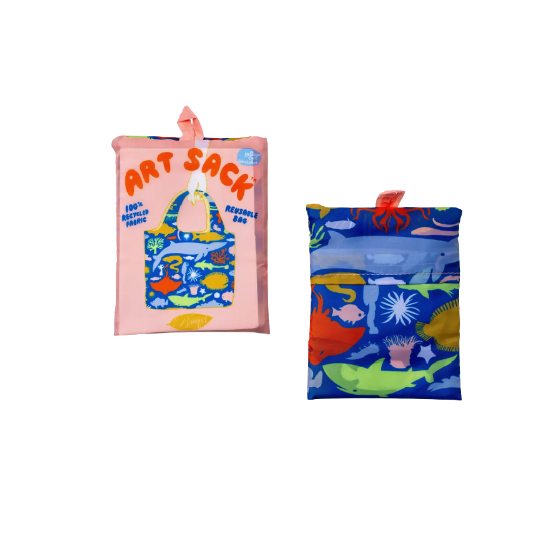 Reusable tote bag shown folded, with the front and back sides visible. The front features colorful ocean-themed artwork and “ART SACK” text, while the back has a blue underwater pattern with sea creatures.