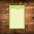 Green Smiski-inspired notepad with a cute lounging character and light grid writing paper