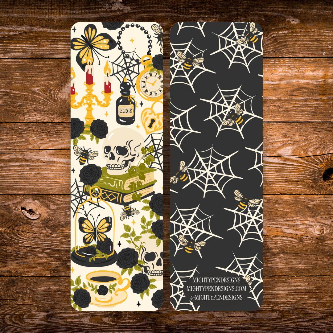 Double-sided gothic bookmark with skulls, black roses, candles, potion bottles, and golden accents on a cream background, paired with a black reverse featuring cream spiderwebs and golden bees.