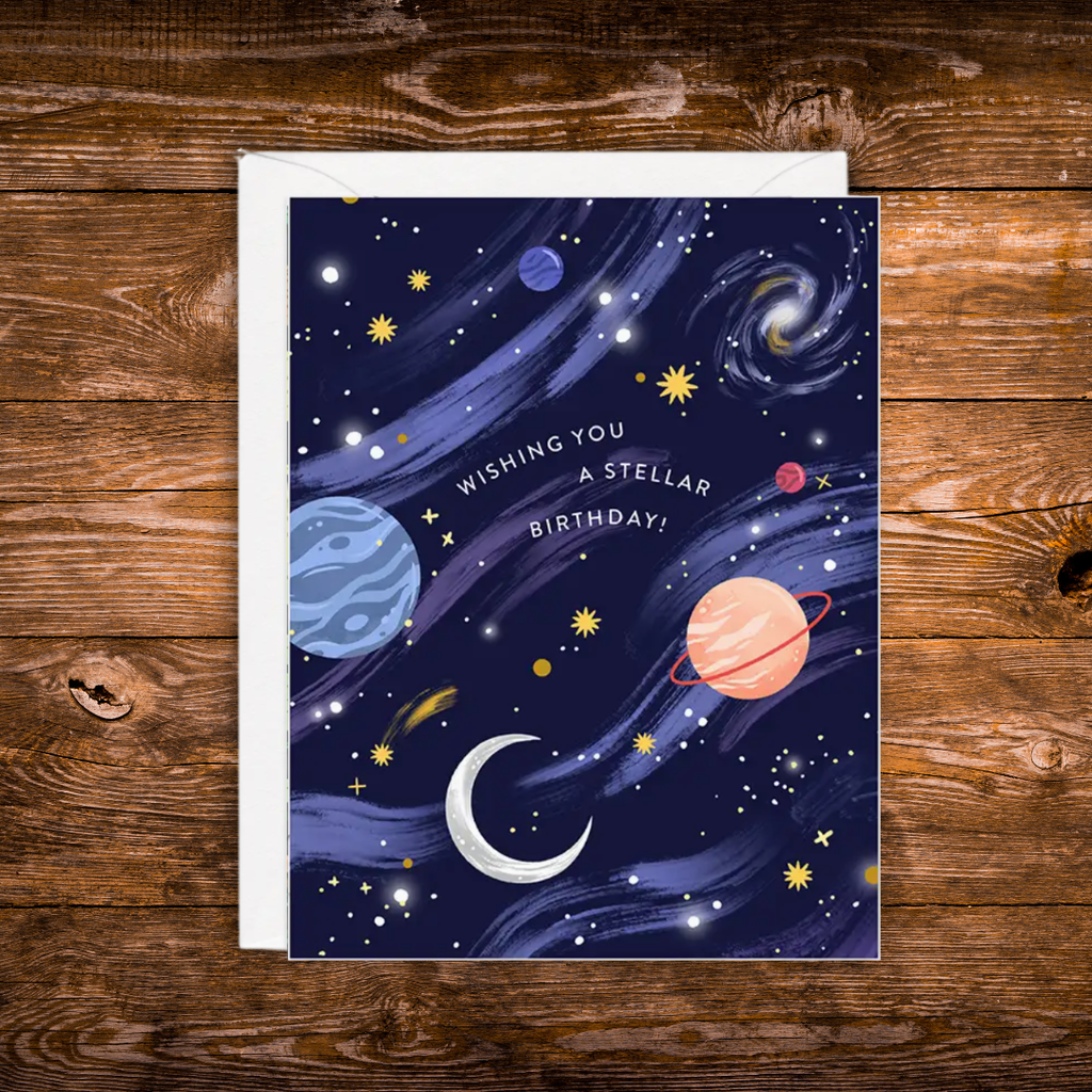 Space-themed birthday greeting card featuring colorful planets, stars, galaxies, and the message "Wishing You a Stellar Birthday!" on a navy blue night sky background.