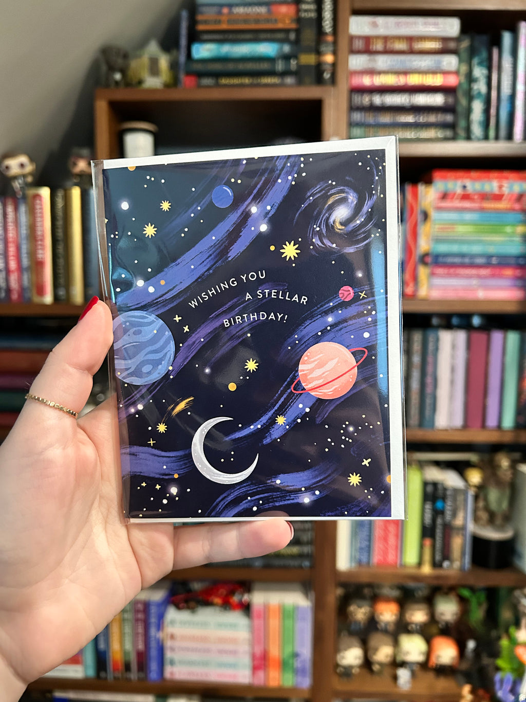 Space-themed birthday greeting card featuring colorful planets, stars, galaxies, and the message "Wishing You a Stellar Birthday!" on a navy blue night sky background.