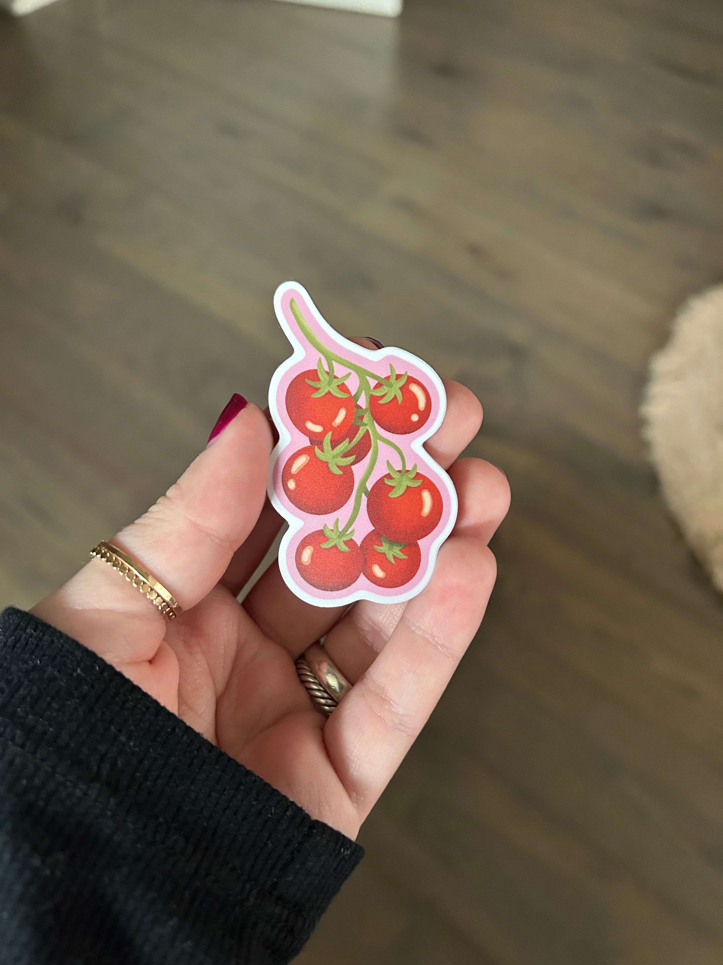 Tomato vine waterproof vinyl sticker with red cherry tomatoes on a pink background