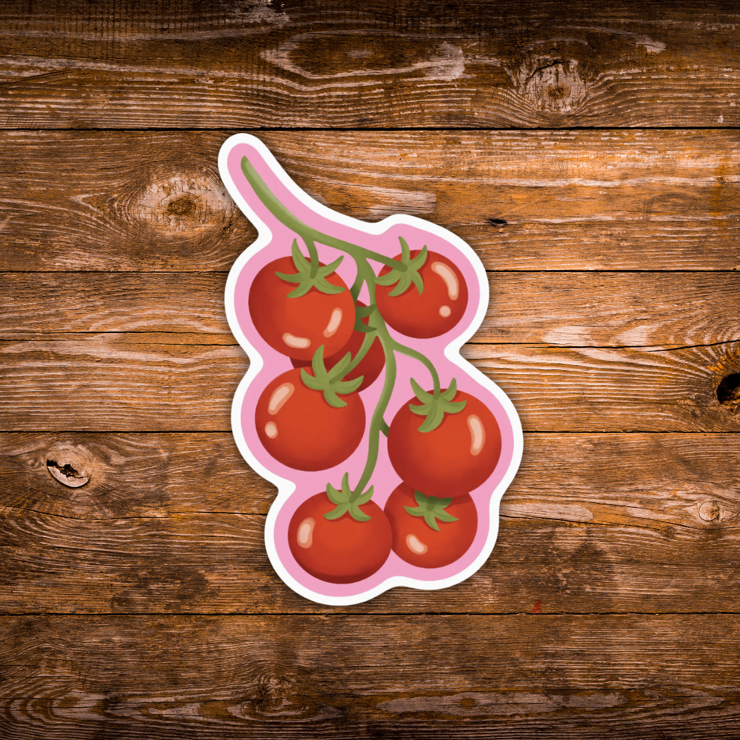 A die-cut sticker featuring a cluster of red cherry tomatoes on a vine with green leaves, outlined in white and pink, displayed on a rustic brown wooden background.
